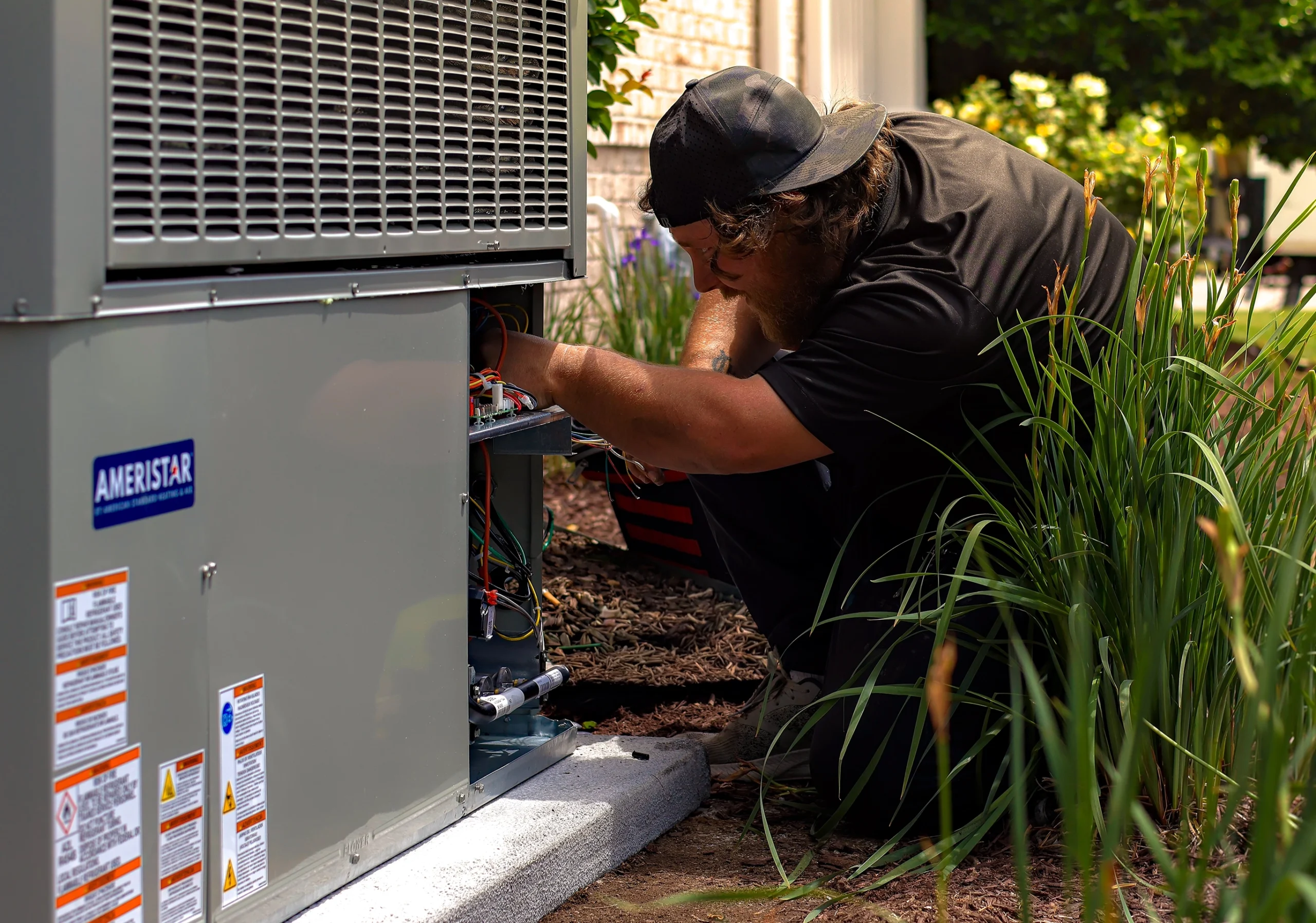 An HVAC technician works on a unit