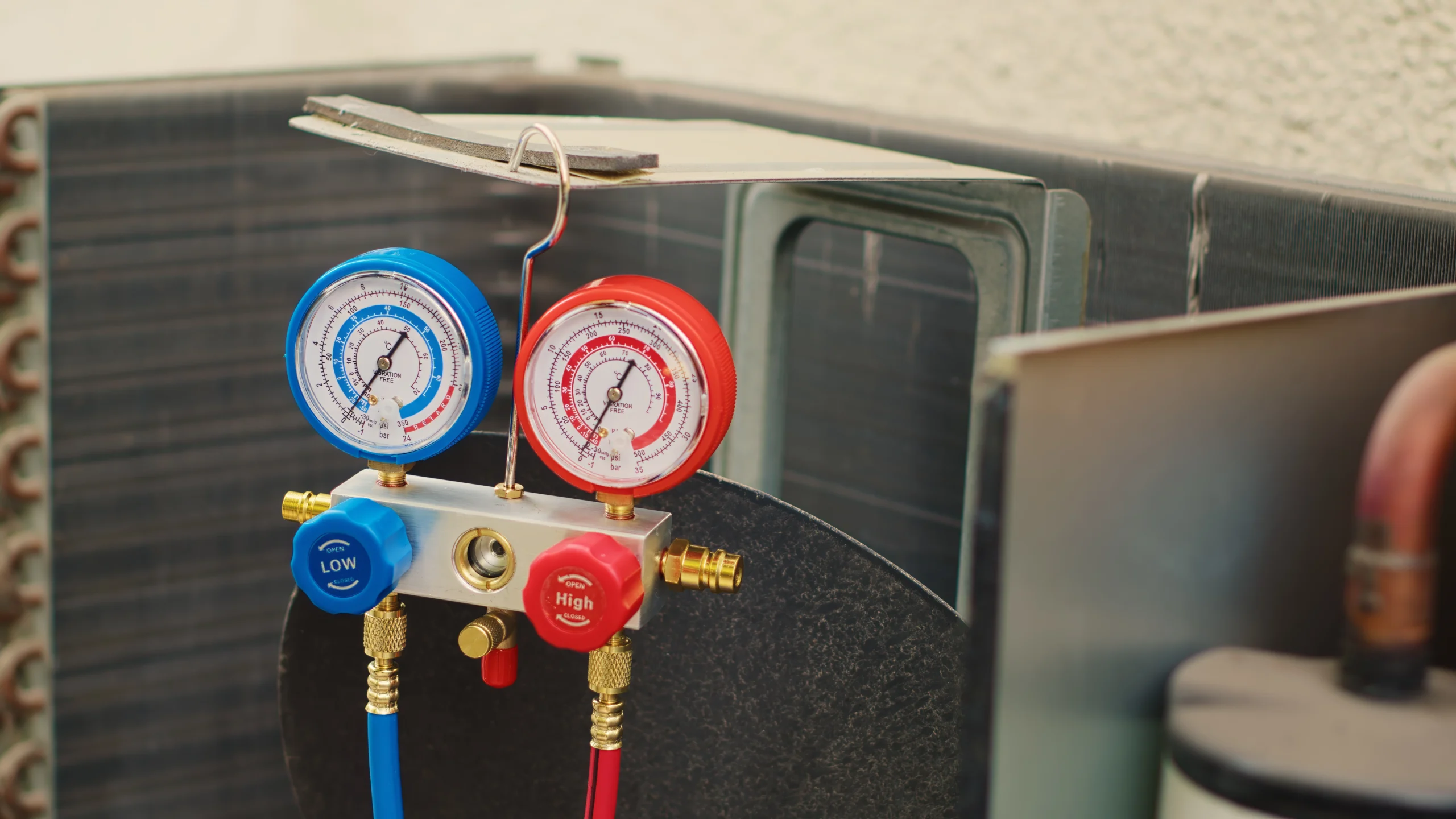 HVAC gauges hanging on an HVAC Unit