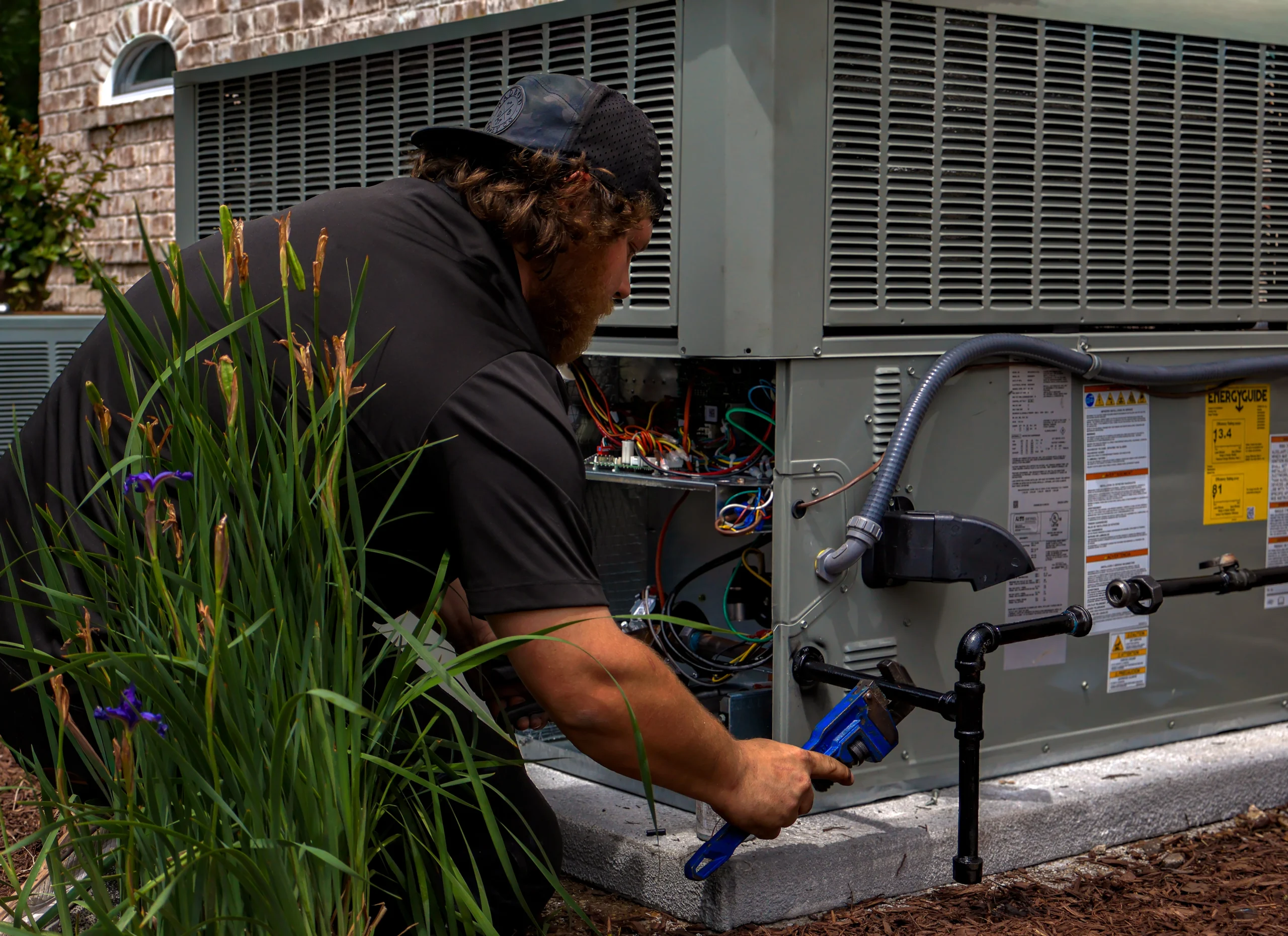 An HVAC technician works on a unit